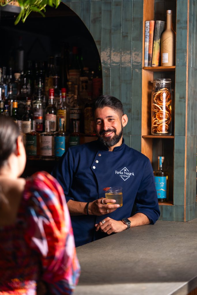 Bartender and guest at Perla Negra in New York