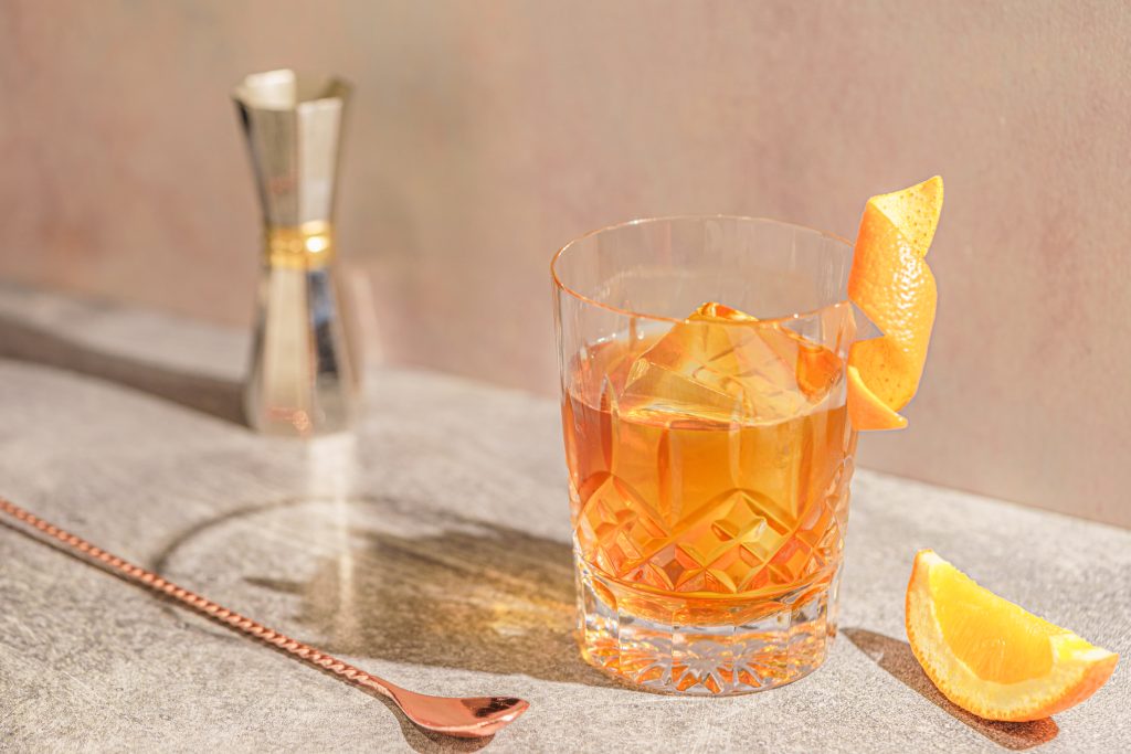Irish cold brew old fashioned cocktail with orange garnish